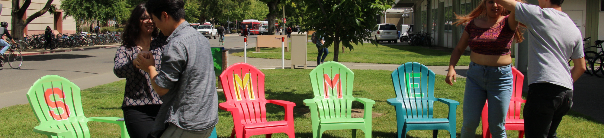 4 students dancing in front of Summer Sessions chairs